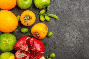top view fresh pomegranate with apples and tangerines on a dark background ripe fruit color