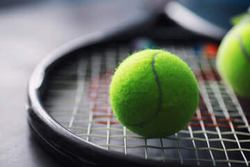 Sport and healthy lifestyle. Tennis. Yellow ball for tennis and a racket on the table. Sports background with tennis concept.