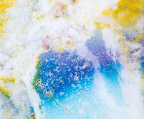Yellow and blue paint on the snow in winter.