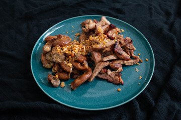 Grilled Pork Neck and Grilled Pork Intestine. Garnish with fried garlic. Local food in Thailand It is a popular food. You can find it at street food stores.