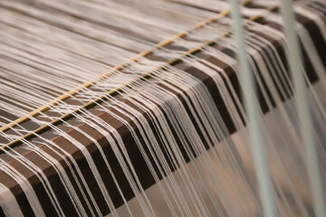 Closeup of traditional manual cotton cloth weaving tool.