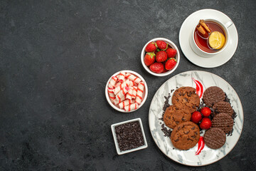 top view choco biscuits with cup of tea on dark background sweet cookie photo