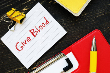 Business concept about Give Blood  with sign on the page.