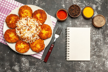 top view tasty fried cutlets with rice and seasonings on a dark background meat rissole food