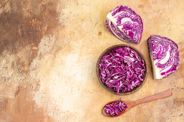 top view a bowl of chopped red cabbage is prepared for salad on a wooden table with space for text in the left corner