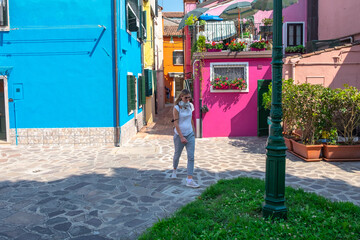 Venice landmark, Burano island canal, colorful houses and boats - 400506596
