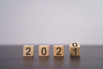 Text 2021 on wooden cube isolated over background.