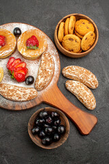 top view delicious pancakes with fruits and sweet cakes on dark background cakes dessert sweet