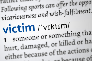 victim in a dictionary page. Word printed in blue color

