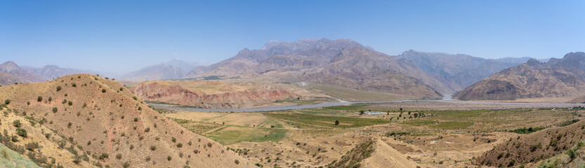 Majestic pastel colored panoramic view of the Panj river valley towards Afghanistan in Darvaz district, Gorno-Badakshan, the Pamir region of Tajikistan