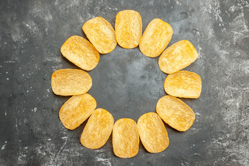 Overhead view of snack party for friends with delicious potato chips on gray background