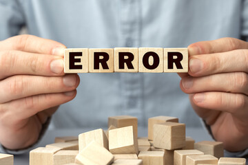 The word ERROR made from wooden cubes. Shallow depth of field on the cubes