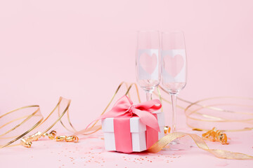 Saint Valentine days background - elegant luxury gift box and pair of champagne glasses with hearts on pink, copy space for your greering text, romance party card, seasonal holiday