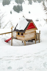 Small wooden cottage in the withe snow