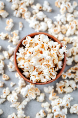 Fototapeta na wymiar Homemade popcorn in a wooden bowl on a grey background