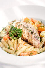 fried chicken breast with penne and saute vegetables pasta dish