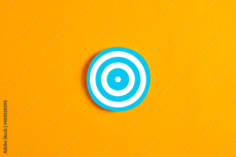 Wall mural blue round circle with a target icon against yellow background.