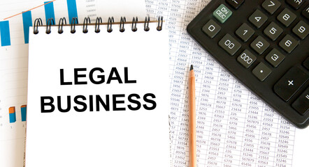 Text in the LEGAL BUSINESS notebook, next to the calculator, pencil and graph reports.