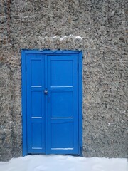 Fototapeta na wymiar old blue door in a wall