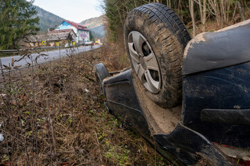 The Car Got Into an Accident on the Mountain Road and fell Upside Down. The Blue Car Turned over in a Ditch near the Highway