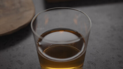 apple cider in glass on concrete countertop