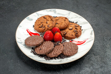 front view delicious choco biscuits for tea inside plate on dark background sweet cookie cake
