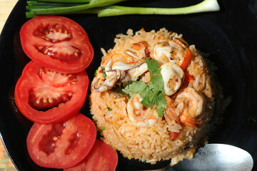 Chili Paste Fried Rice Tom Yum - Squid and Shrimp - with spicy flavor is a healthy food that contains many kinds of herbs - Thai food.