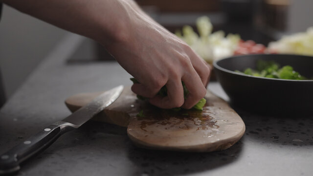 Man Hand Take Chopped Romaine Lettuce From Wood Board To Make Salad