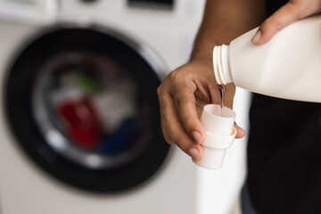 Pour some laundry detergent on the clothes and put it in the washing machine.