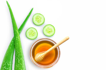 Fototapeta na wymiar Aloe vera lesf with cucumber and honey isolated on white background. Natural medicine plant, beauty spa and skin care concept. Top view. Flat lay.