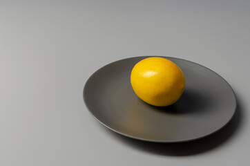 Fresh lemons on gray background. Color of the year 2021.