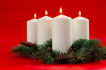 White christmas candles on red background, Advent. 4 burning candles.