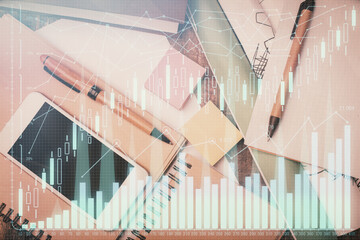 Multi exposure of forex graph hologram over desktop with phone. Top view. Mobile trade platform...