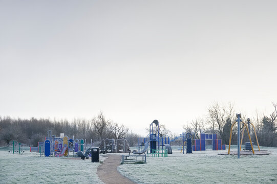 Play park outdoors with frozen grass during winter