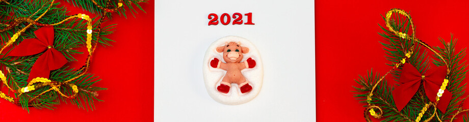 New Year 2021. Christmas greeting backgrounds. Holiday gifts and Christmas sales. The symbol of the year of the bull on a red background with elegant sparkling ornaments and snowflakes.