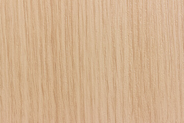 The surface of a light beige wood board.