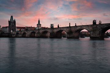 Fototapeta na wymiar Charles Bridge on the Vltava River at sunset and colorful clouds