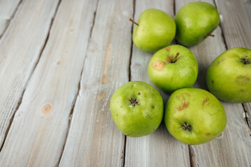 green apple on white wooden background