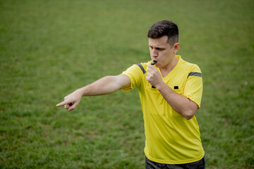 Referee showing on penalty while gaming. Concept of sport, rules violation, controversial issues,...
