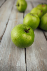 green apple on white wooden background