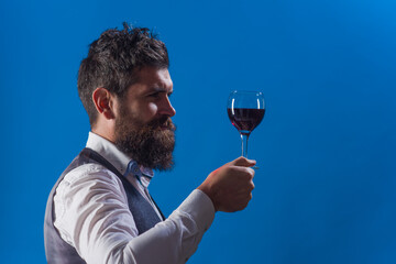 Wine tasting. Sommelier. Wine degustation. Man with alcohol. Bearded man with glass of wine. Man...