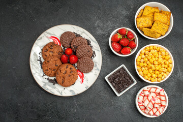 top view different eatings biscuits fruits and candies on dark background tea sweet crisp photo