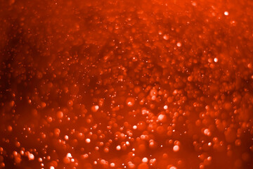 Red glitter vintage lights background. White bokeh on red background.