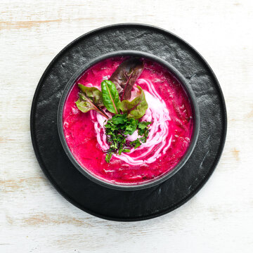 Red beet soup with sour cream. Ukrainian cuisine, Borsch soup. Top view. Free space for your text. Rustic style.