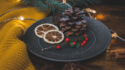 Christmas decorations on a gray plate with lights