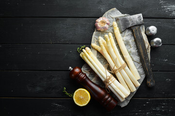 Organic food. White asparagus on a black background. Healthy food. Top view. Free space for your text.