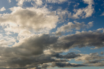 Fototapeta na wymiar Background. A blue sky with white, airy, cumulus clouds.