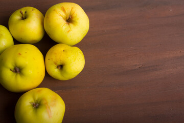 Organic apples on wooden background