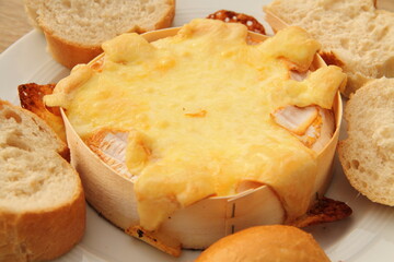 an oven-baked camembert with bread rolls