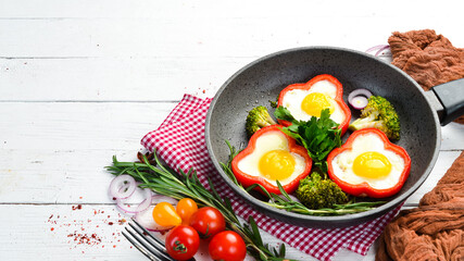 Fried egg with sweet pepper on a black plate. Top view. Free copy space.